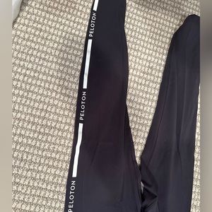 NWOT black Peloton Interactive leggings. Peloton branding down the side of legs